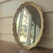 Vintage gold oval mirror dresser caddy.  Gold filigree dresser mirror.