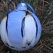 Hand painted glass ornament with penquins
