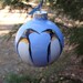 Hand painted glass ornament with penquins