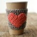 Natural coffee cup cozy with pumpkin colored heart by The Cozy Project