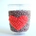 Natural coffee cup cozy with pumpkin colored heart by The Cozy Project