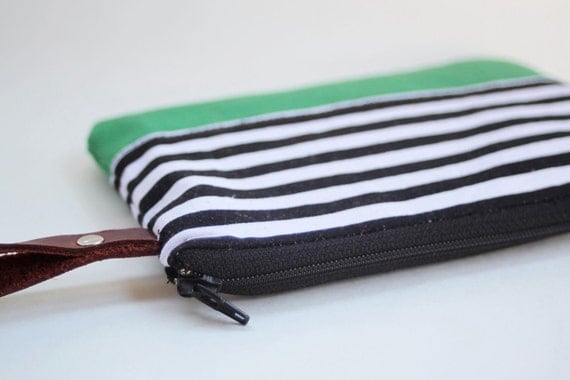 wristlet clutch in black and white strip with green bottom