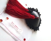 Red and black nipple tassels