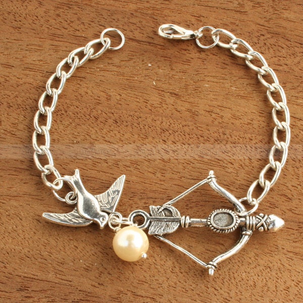 Charm bracelet-Mockingjay bracelet with Katniss Bow and Peeta Pearl inspired by The Hunger Games