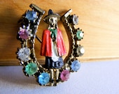 Beautiful Horseshoe Brooch - Girl with Pointy Hat and Red Cape Surrounded by all the colored rhinestones