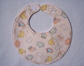 Baby bib, four soft layers, reversible, peach with duckys, moons and bears