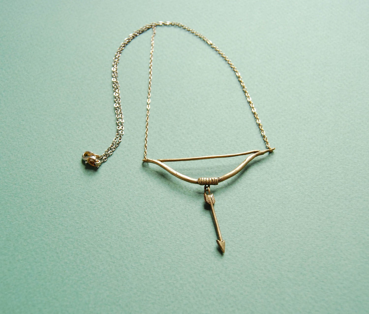 Golden bow and arrow necklace