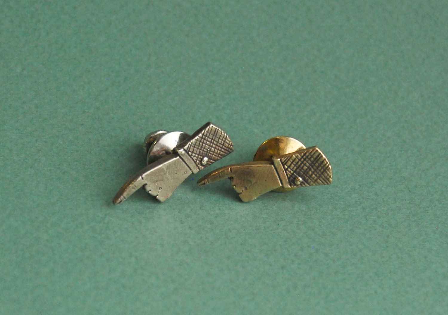 Pointing hand brass lapel pin