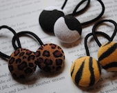 Fabric covered  button pony o's in leopard cow and tiger prints