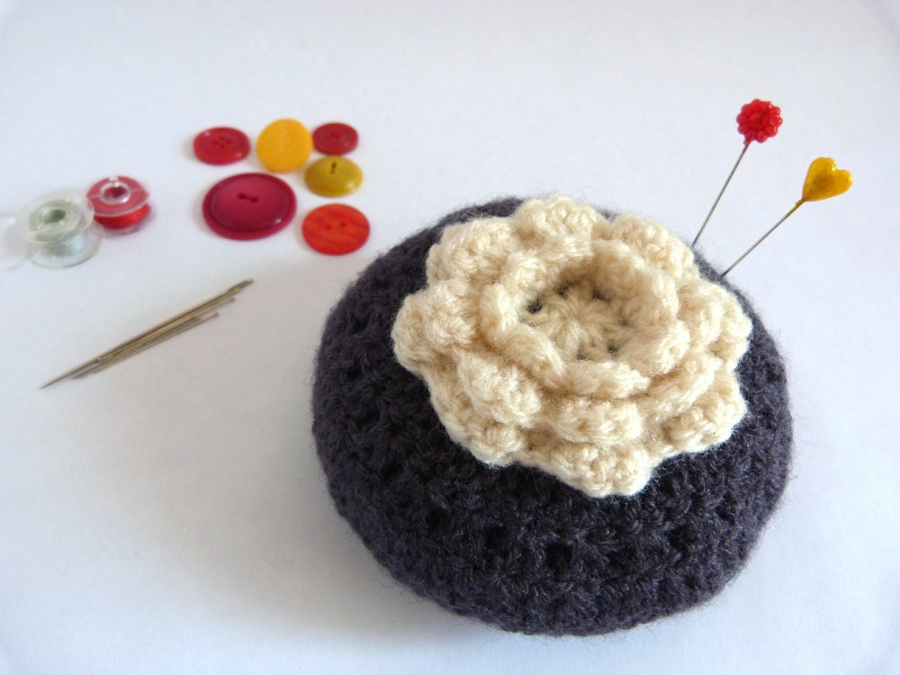 white flower on grey. round crochet granny pincushion