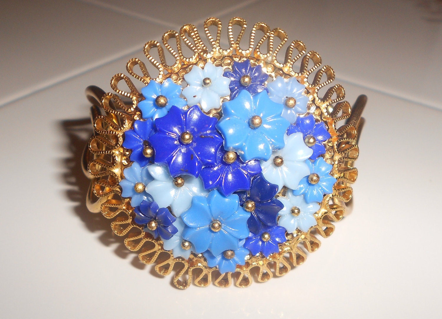 Vintage floral cuff hinged bracelet with celluloid blue flowers