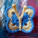 A blue butterfly-hand crochet brooch