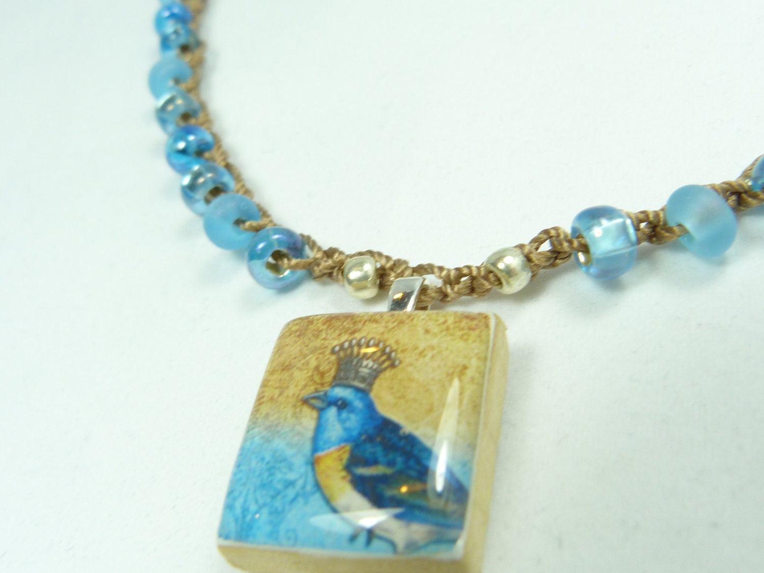 Beautiful crochet necklace with crowned bird scrabble pendant, teal blue crystal beads, beautiful boho style all year long.
