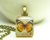 Scrabble tile pendant necklace - orange monarch butterfly design on beige - 24 in bronze colored necklace.