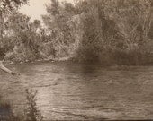 Vintage/ Antique photo of a man trying to fish in a river
