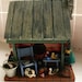 Log Cabin Birdhouse - Fishing & Hunting Camp with duck decoys, creel, dog and stone chimney