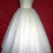 A 50s inspired wedding gown, intricately detailed corset cocktail dress