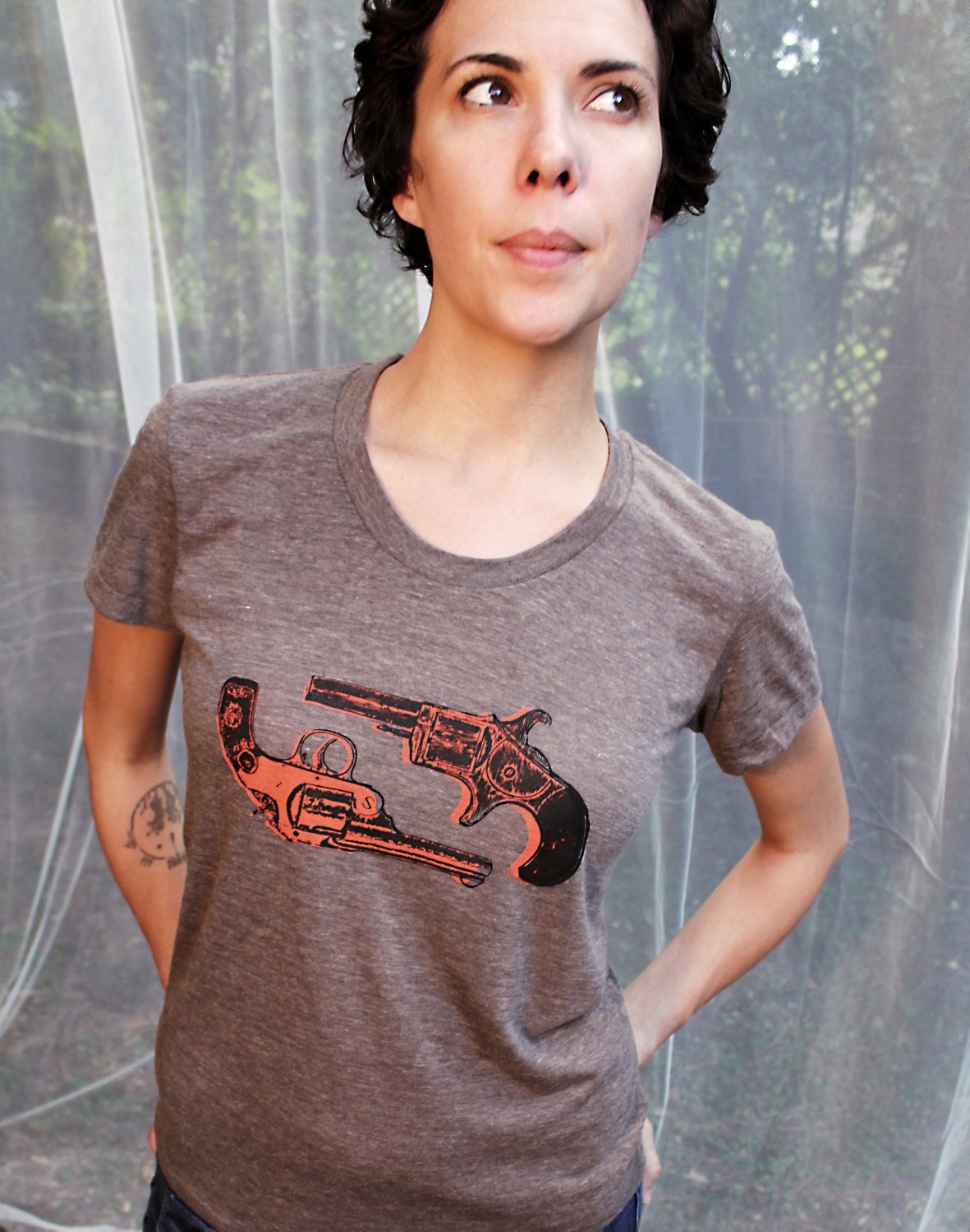 Dueling Victorian revolvers in orange on a brown women's t-shirt
