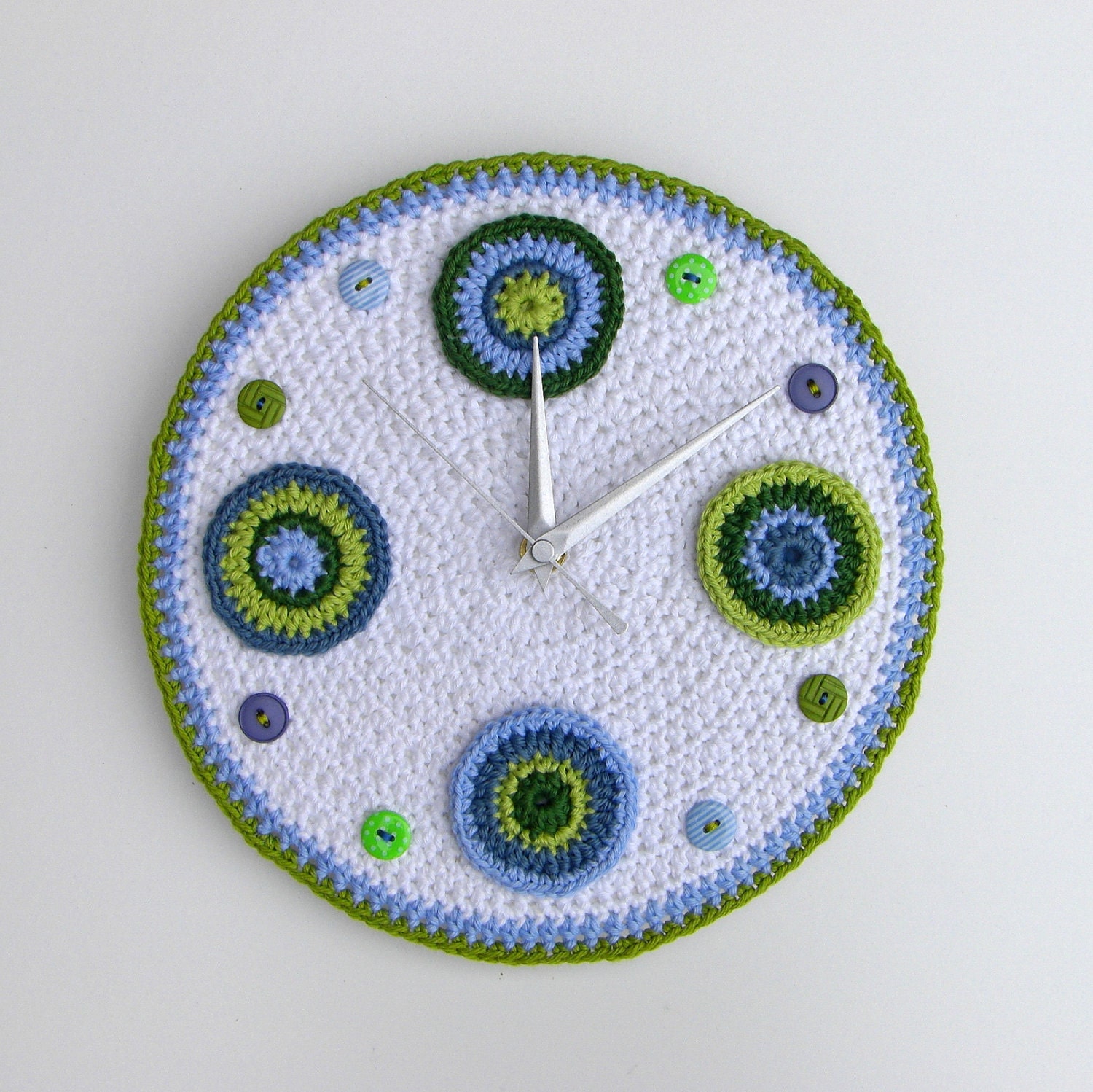 Crochet wall clock with blue and green circles and buttons