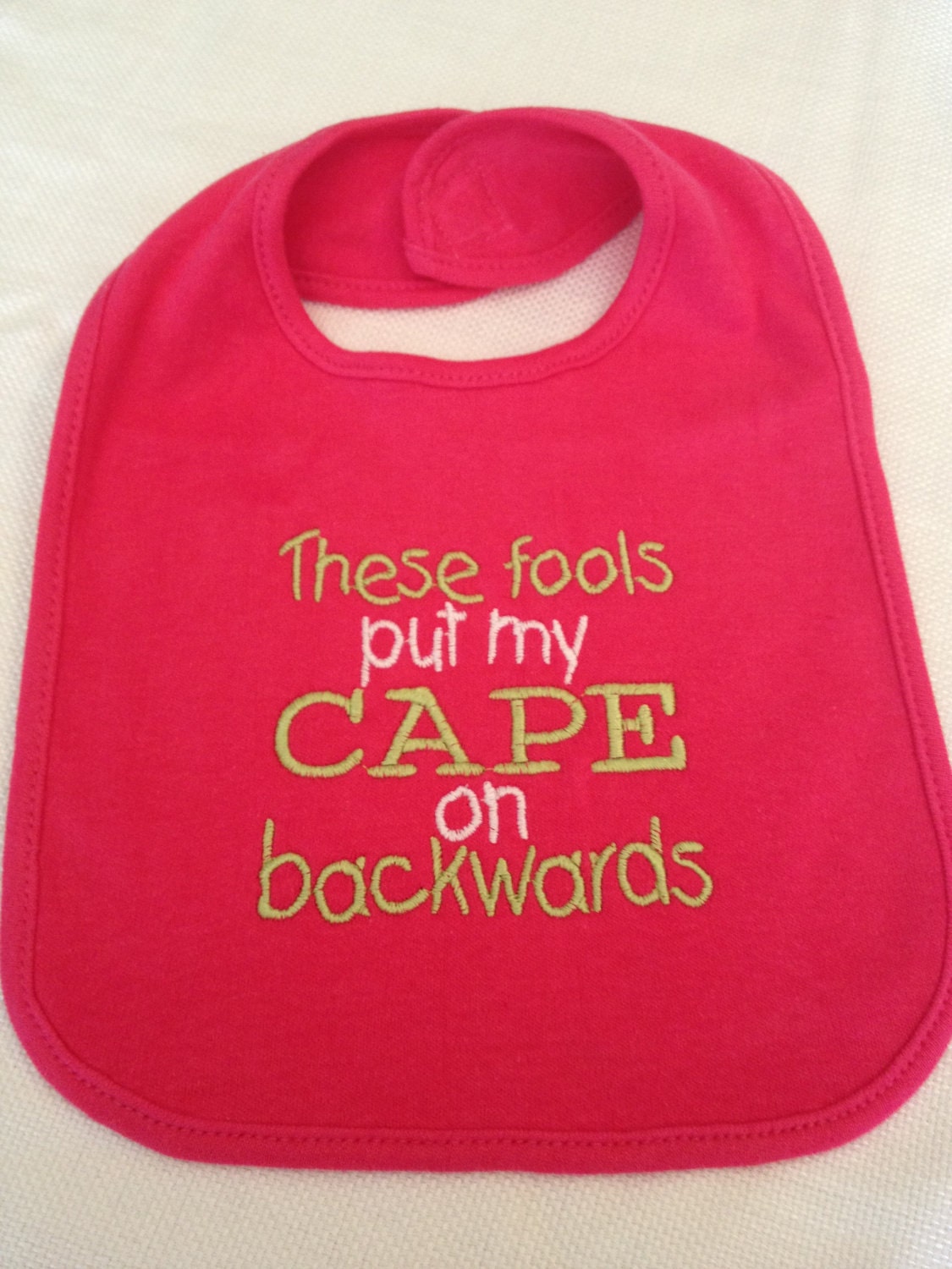 These fools put my cape on backwards - Large Embroidered Bib