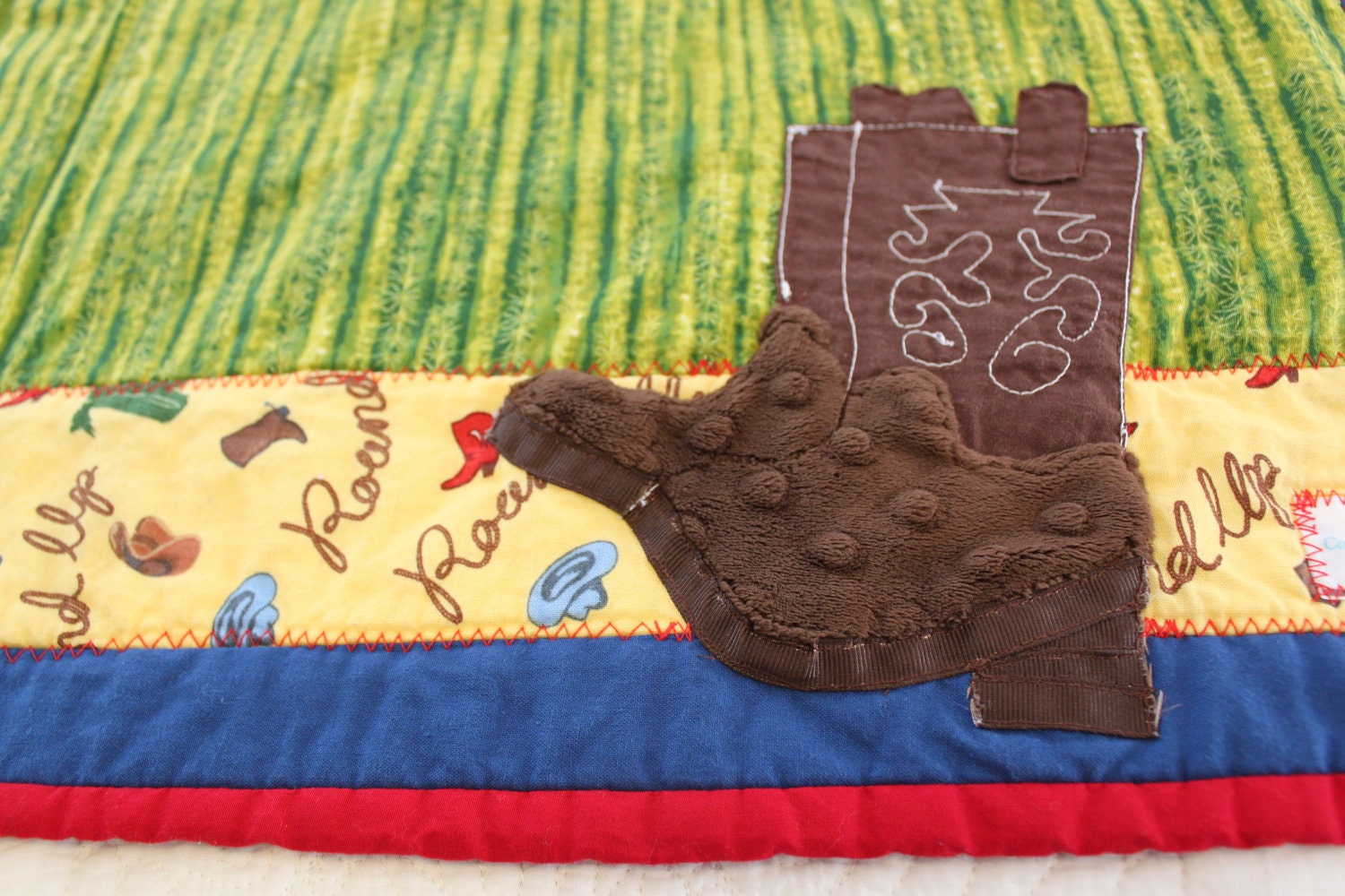 ChristmasInJuly Boy's Cowboy Quilt, crib/toddler size, Rodeo scrappy strip blanket with appliqued cowboy boot, OOAK