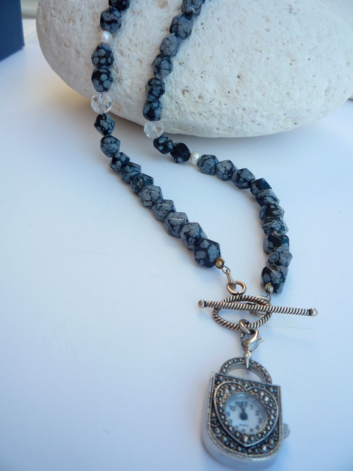 Long necklace with Snowflake Obsidian semiprecious stones and watch pendant.