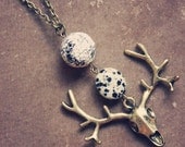 spell.  a long beaded deer skull necklace.