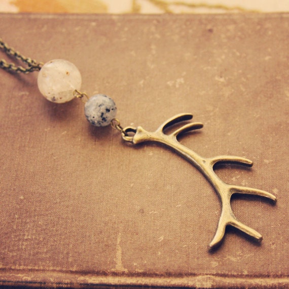 tivah.  a long beaded brass antler necklace.