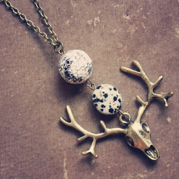 spell.  a long beaded deer skull necklace.