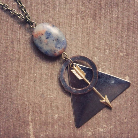cosmo.  a geometric arrow and astral bead necklace.