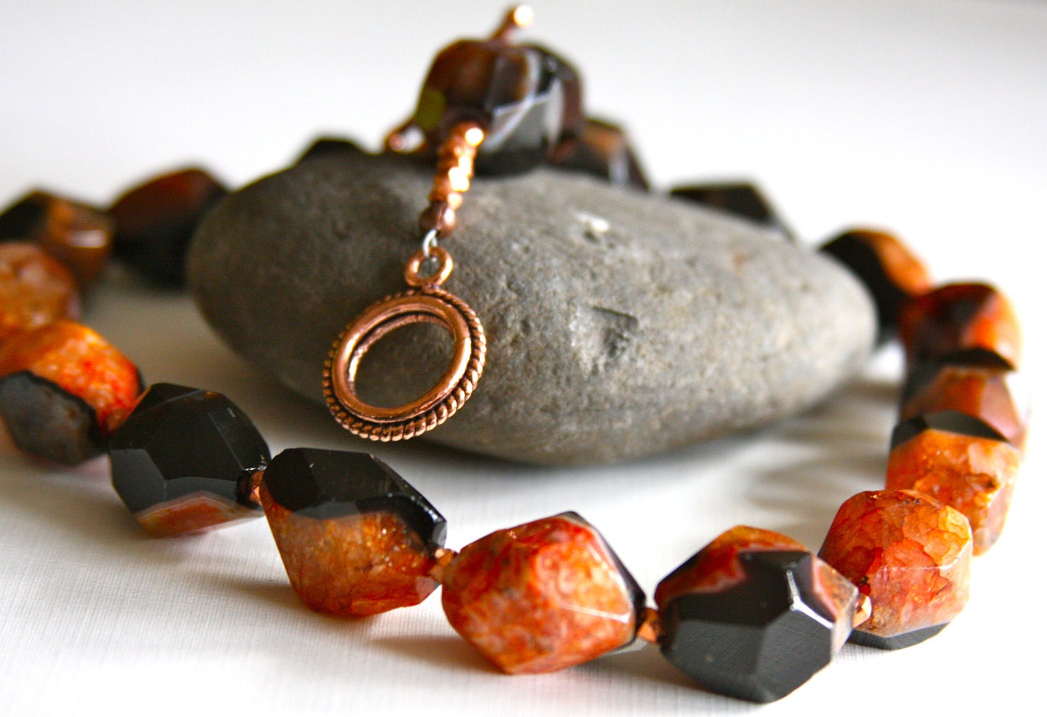 Necklace made with black and orange agates and accented with copper beads