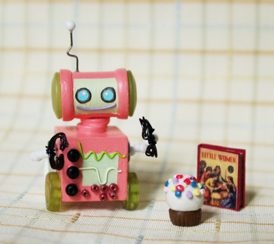 Pink Miniature Wooden Robot with a Book and a Light Snack