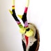 TWO'S COMPANY PAIR of neon bright enamelled painted antique deer skulls and antlers