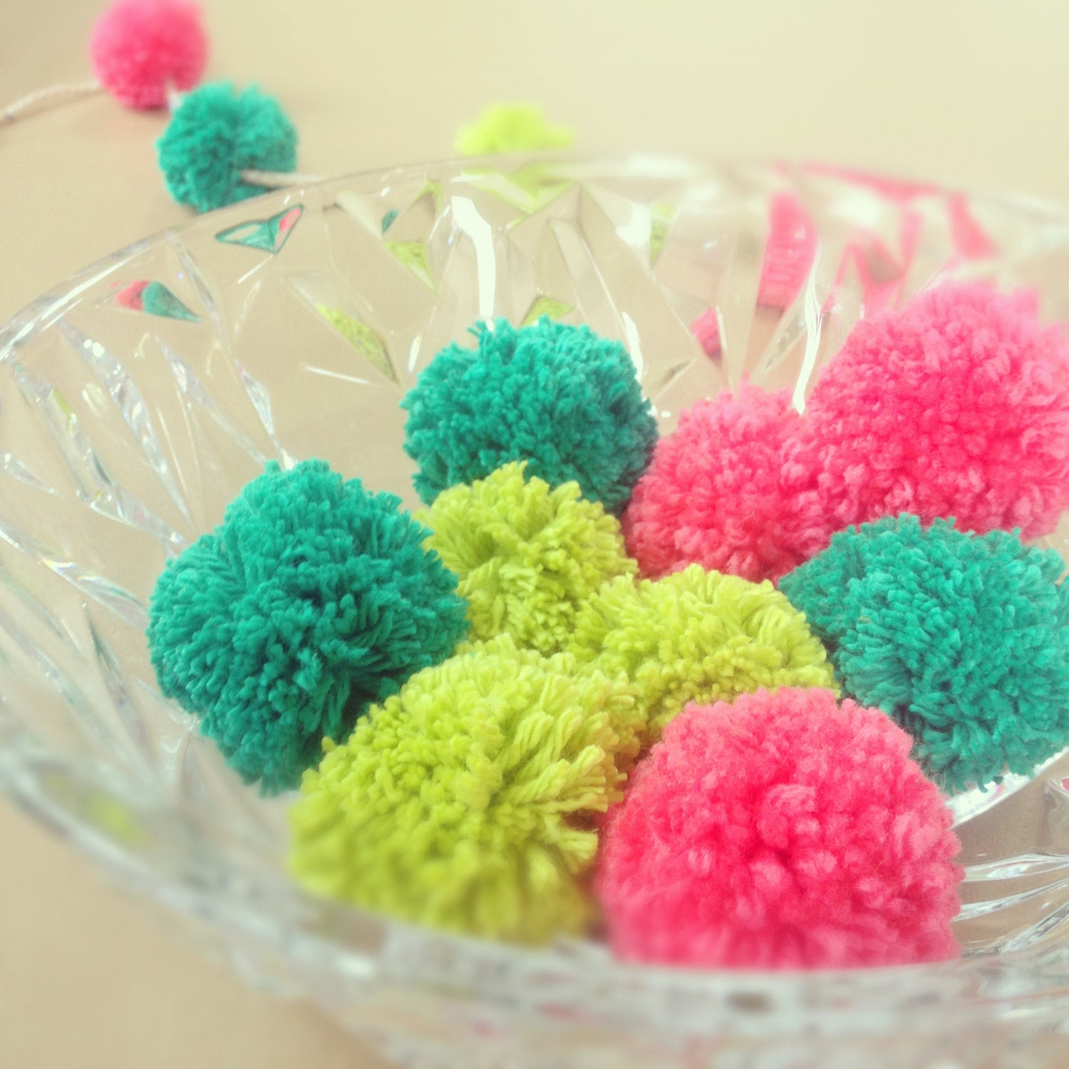 nine handmade pom pons, in neons. Sit beautifully in a bowl. brighten up any room, great for parties. 9 per order.