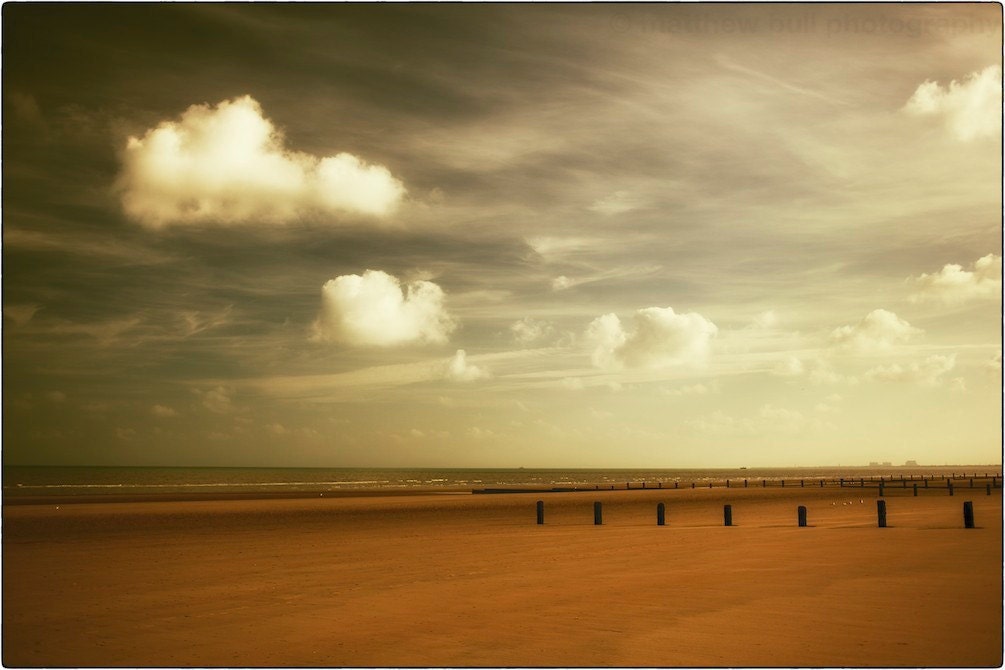 On Dymchurch Beach - golden autumnal reds and coppers with bright white clouds - matthewbull