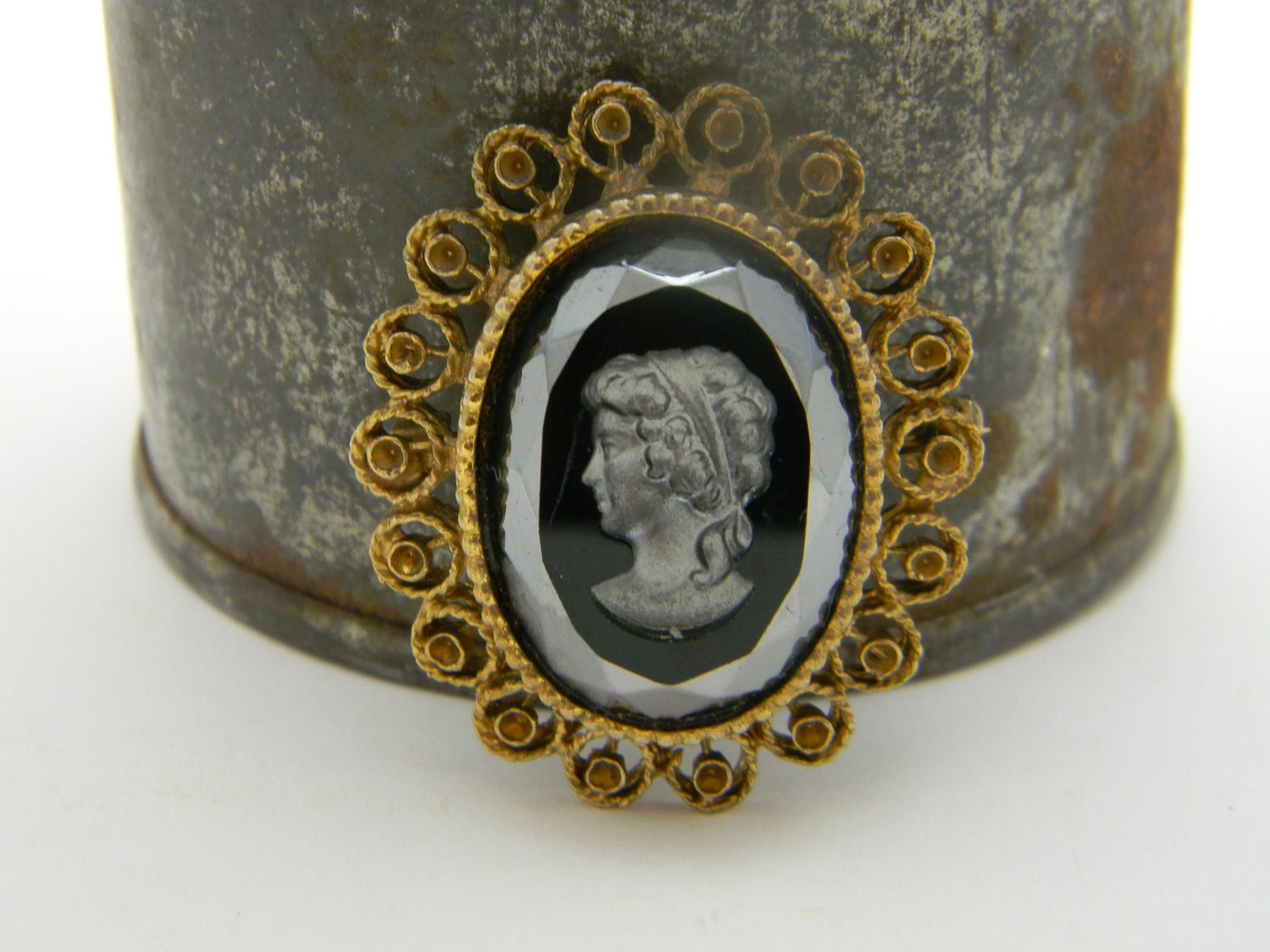 Black glass carved vintage cameo with ornate gold trim