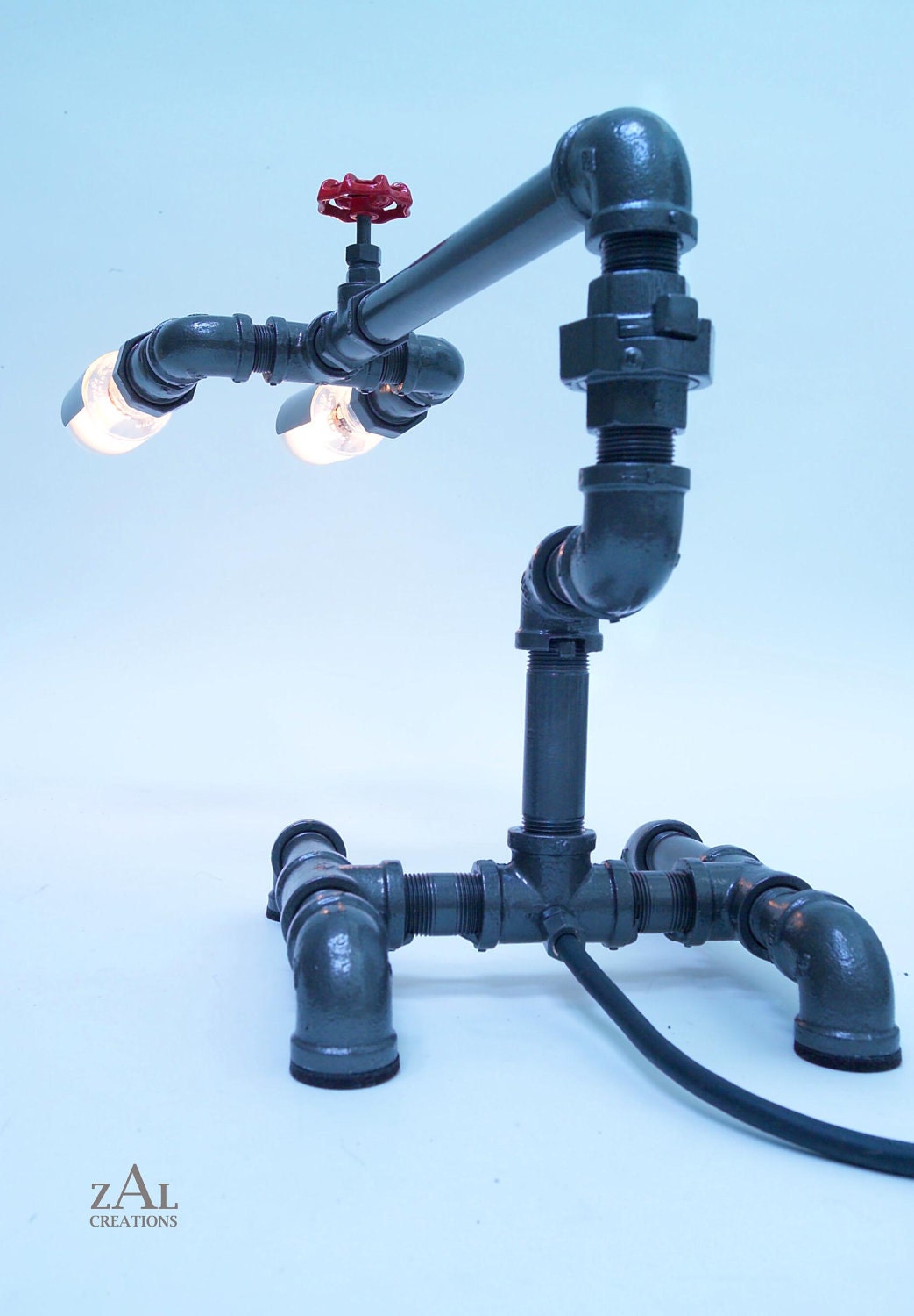 Desk lamp. Beer bottles. Plumbing pipe & fittings. Table lamp.