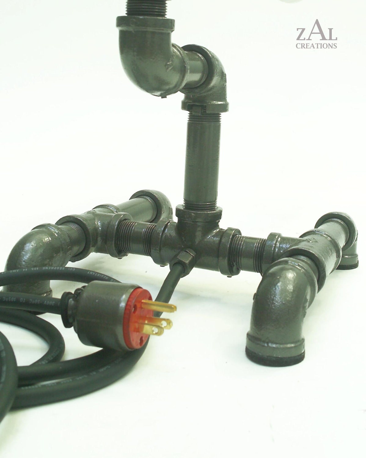 Desk lamp. Beer bottles,  Plumbing pipe & fittings. Table lamp.