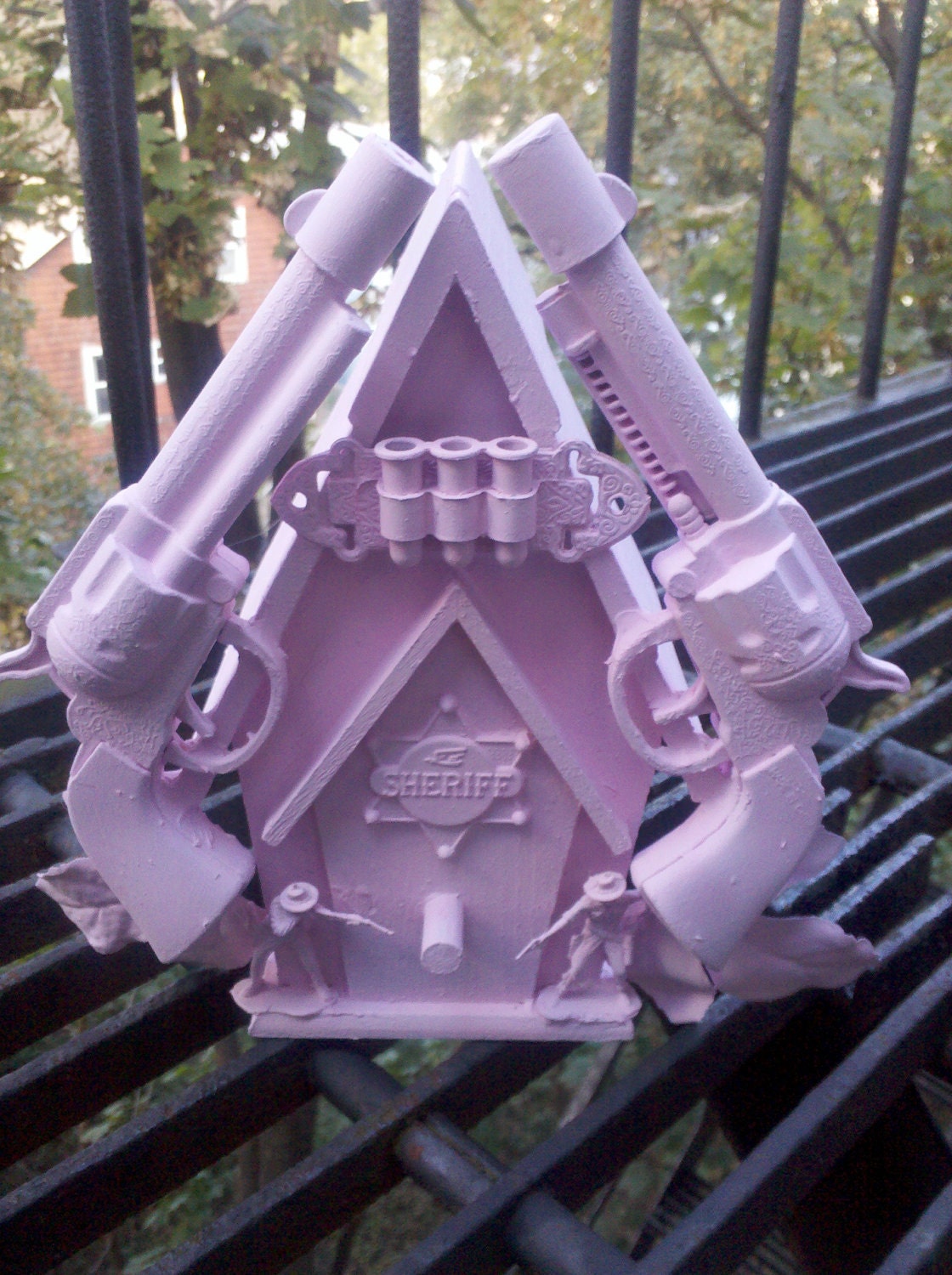 pink cowboy birdhouse sculpture