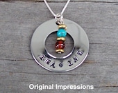 Imagine pendant necklace made of stainless steel with decorative turquoise, garnet, and brass beads on a sterling silver box chain.