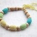 Teething necklace in aqua blue/ turquoise, light yellow and light green. Crochet wooden beads nursing necklace for her.