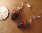 Chocolate-covered strawberry earrings made from polymer clay.