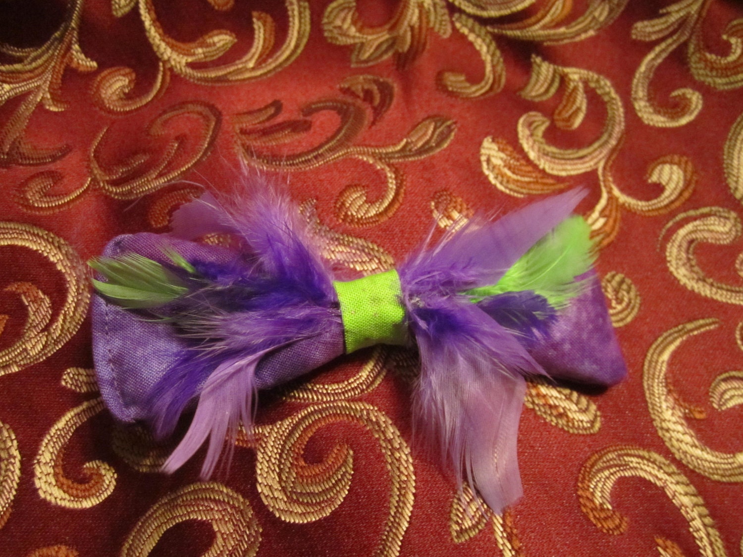 purple and green feathered hair bow