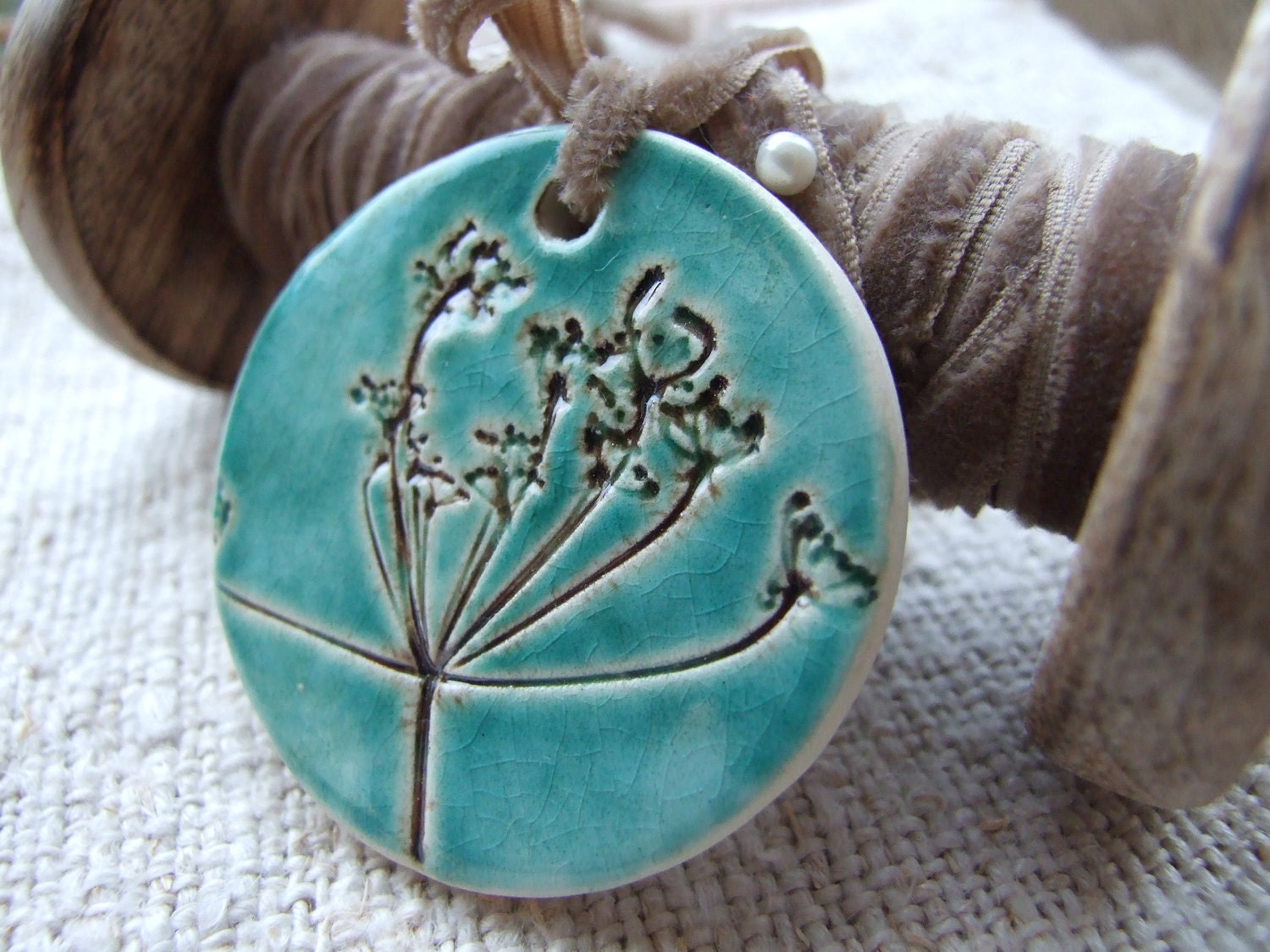Butterfly pendant, bronze and turquoise crackle glaze, tied with a butterscotch vintage velvet ribbon