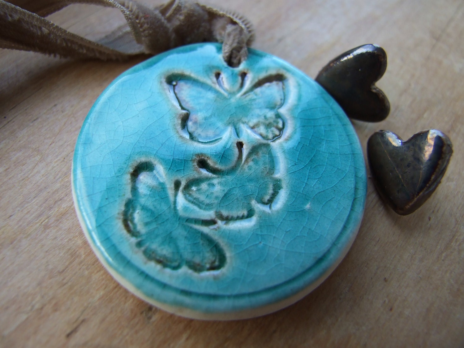 Butterfly pendant, bronze and turquoise crackle glaze, tied with a butterscotch vintage velvet ribbon