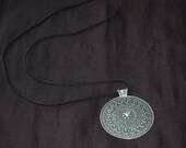 Long black leather strap necklace with gunmetal grey medallion