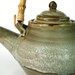 Teapot and tea bowls set with bamboo handle in olive green celedon