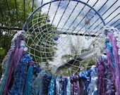 Dreamcatcher Wall Hanging - Ocean Waves - shades of blue, purple colours of novelty yarn drifts down from web with beads and feather