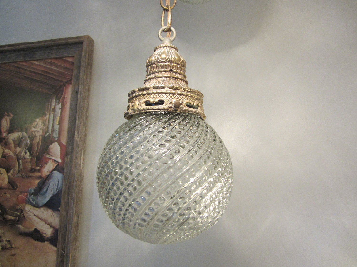 Pair of vintage 70's brass and glass swag hanging globe light fixtures