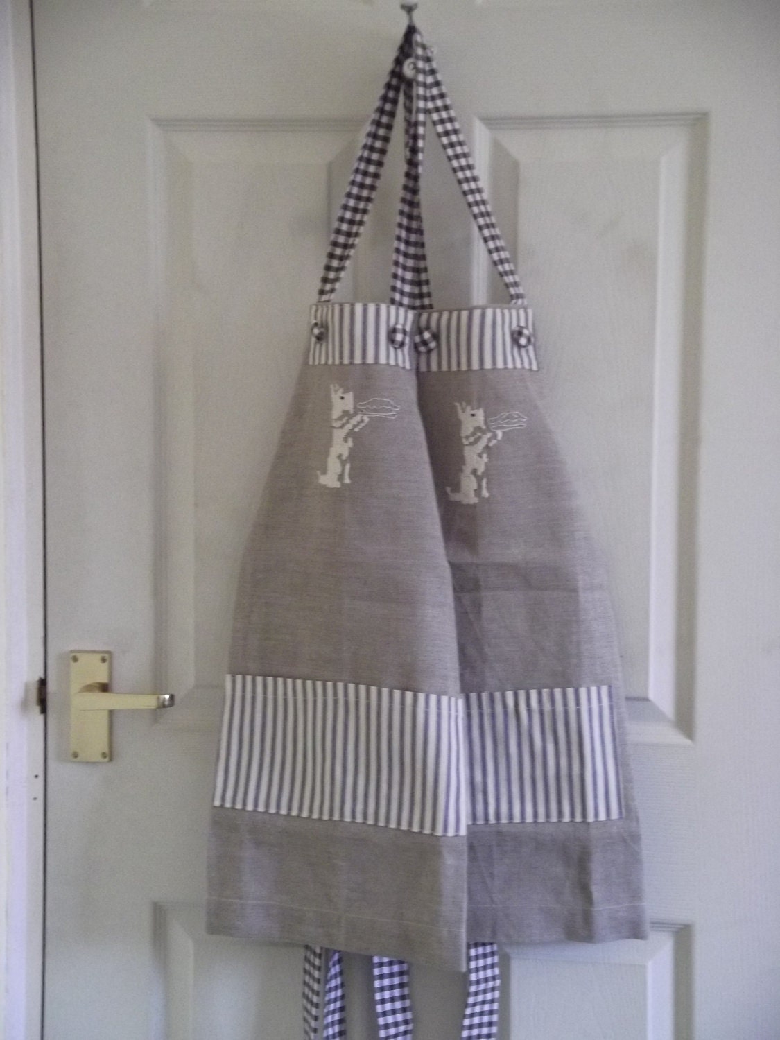 Child's apron , linen, handembroidered with cream scottie-with blue and white ticking pocket
